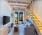 Heller Wohnbereich mit Treppe zur Empore mit extra Bett